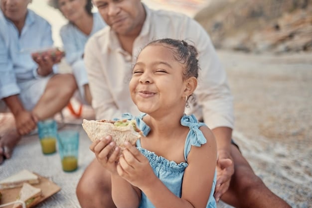 A group of Mexican fishermen and their families gathered together, smiling and sharing a meal of freshly caught fish on a colorful patio overlooking the ocean. This scene showcases the community spirit and the importance of fishing to their livelihoods and culture, highlighting the positive impact of the Bienpesca program on family well-being.