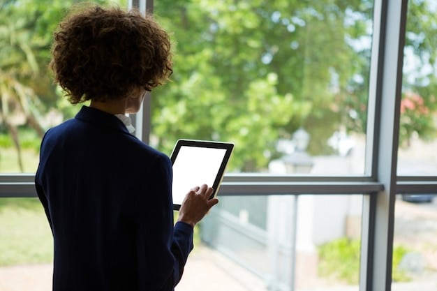 A person standing in front of a government office building, presenting a digital document displayed on a smartphone screen to an official. The document is clearly identified as a social program beneficiary certificate.
