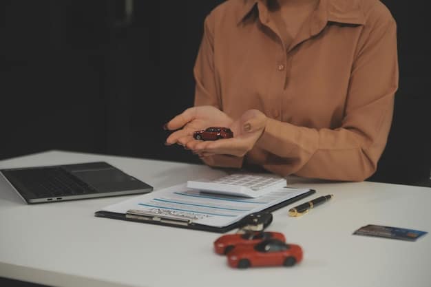 A person using a calculator and a laptop, researching and comparing different car financing options on a table with car brochures.