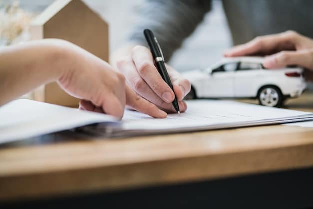 Close-up of hands signing a document for a car loan refinance in an office setting.