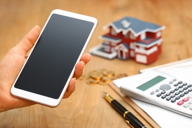A close-up of hands typing numbers into a mortgage calculator on a smartphone, with a house key and a small model house on the side. The focus is on the calculator display.
