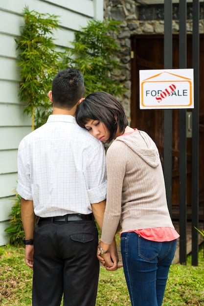 A young Mexican couple looking at a house blueprint with an INFONAVIT logo subtly placed in the corner, representing their dream of home ownership.
