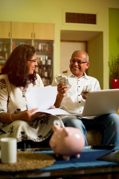 A diverse group of Mexican retirees participating in a workshop about financial planning and retirement benefits, smiling and engaged.
