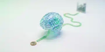 Representación visual de la desconexión temporal del cerebro en el ahorro, con un modelo cerebral acrílico y caminos divergentes hacia recompensas inmediatas y futuras, en tonos de verde y azul.